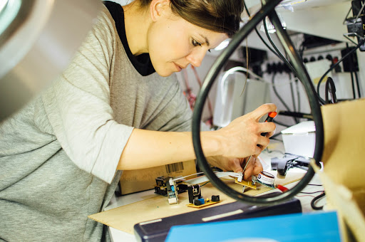 A person making an air quality sensor in a laboratory