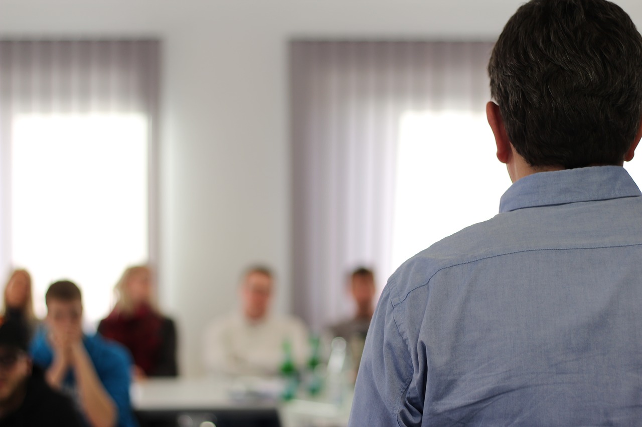 Person stands in front of a class 